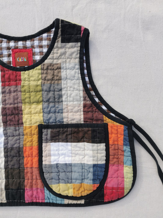 Handmade colourful quilted patchwork linen vest by KABIN NZ with a patch pocket, brown gingham lining and black binding.